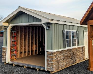 12x20 Peak Garage Meadow Green Vinyl Board and Batten Siding with Cobble Stone on Eave Side